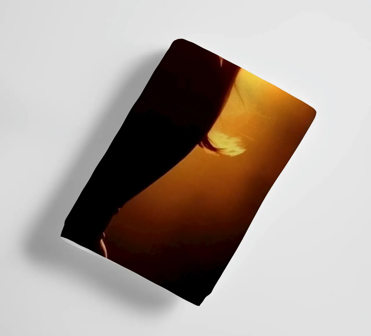Silhouette of a woman against a warm glowing backdrop towel by DesignDoodle