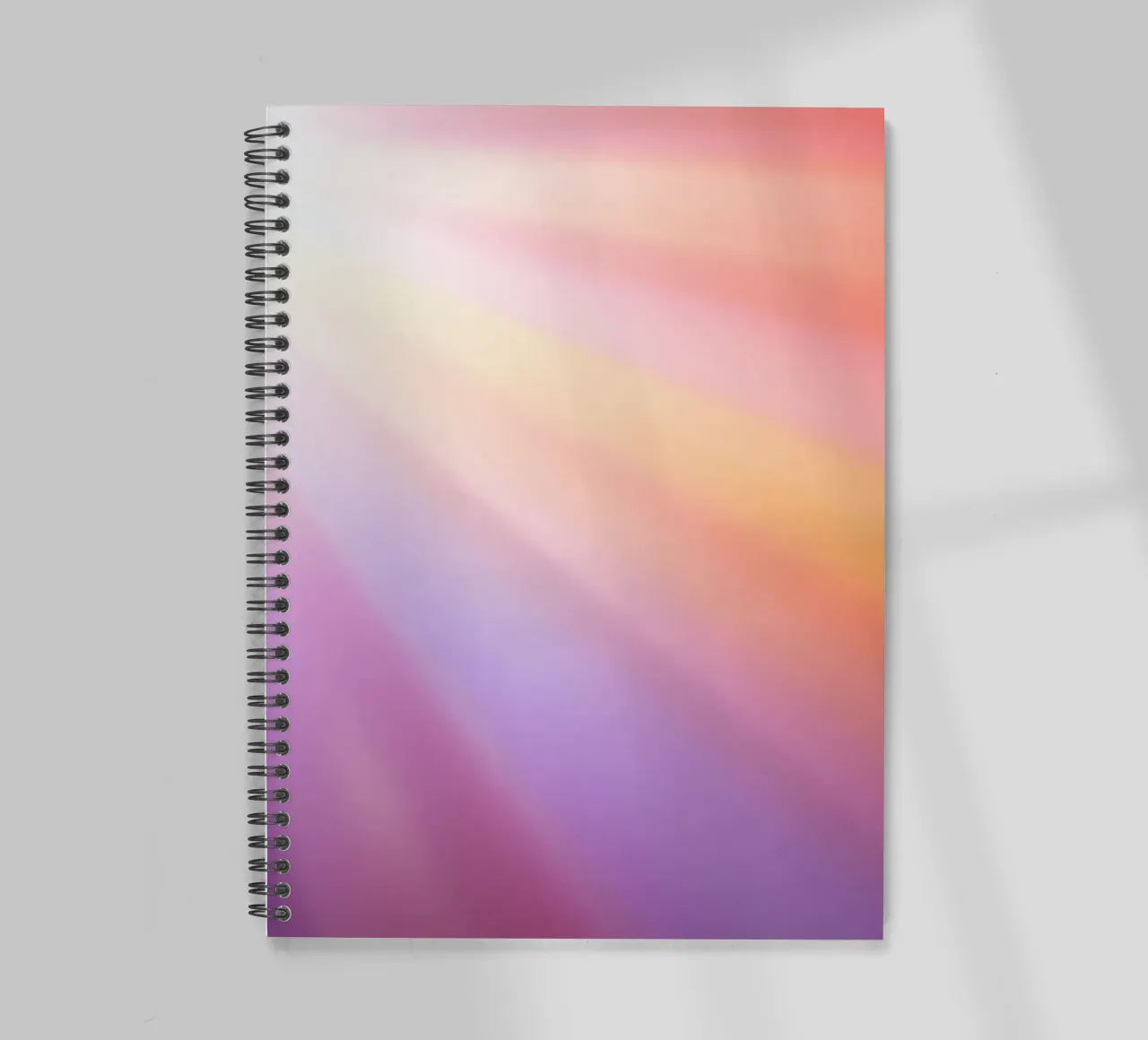 Bright rays of sunlight create a colorful gradient spiral notebook by DesignDoodle