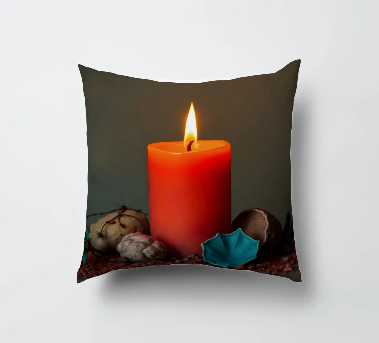 Bright orange candle surrounded by decorative stones decorative cushion by DesignDoodle