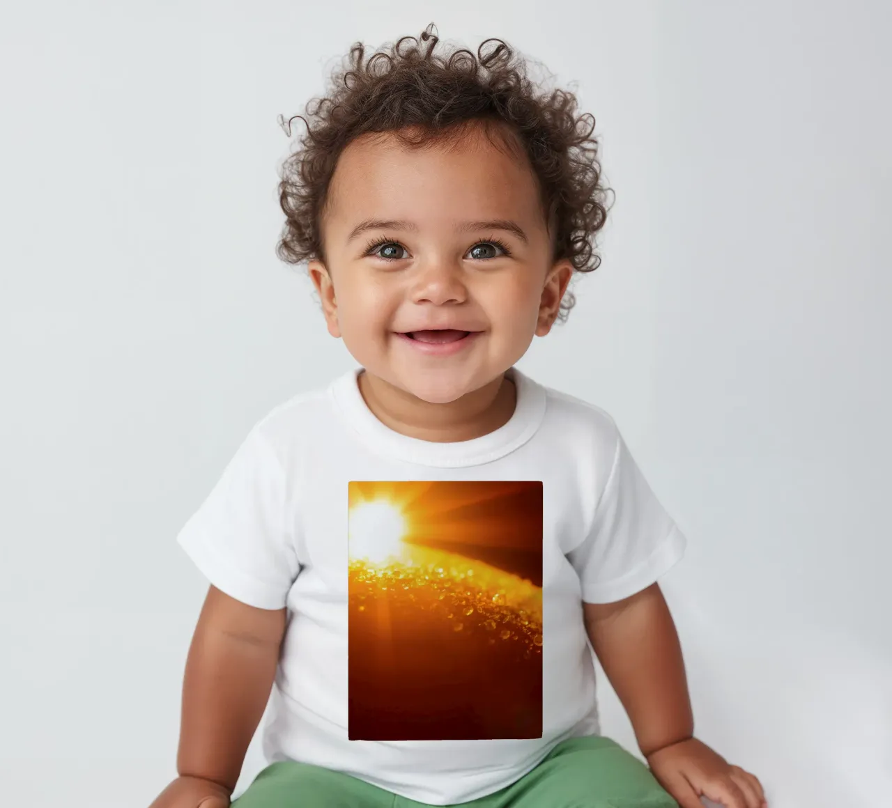 Sunlight glistens on a dewy surface at dawn, creating a warm baby t-shirt by DesignDoodle