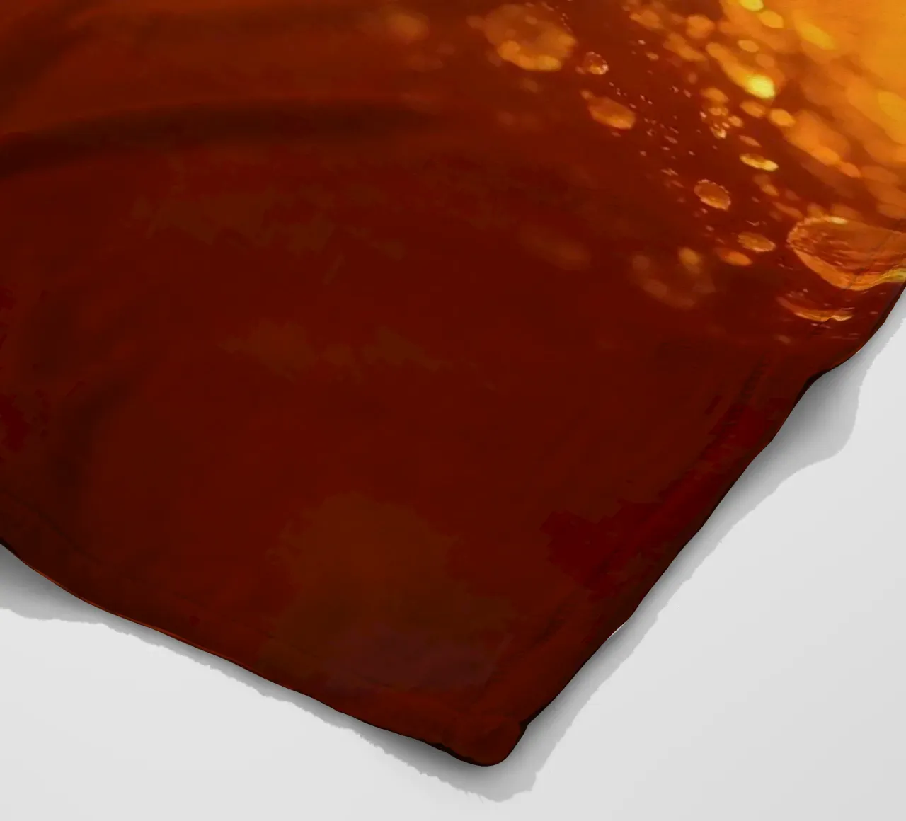 Sunlight glistens on a dewy surface at dawn, creating a warm fleece blanket by DesignDoodle