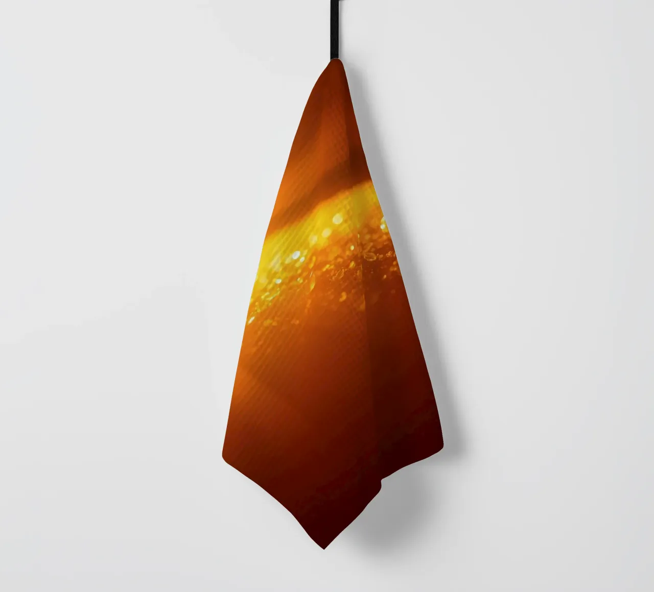 Sunlight glistens on a dewy surface at dawn, creating a warm tea towel by DesignDoodle