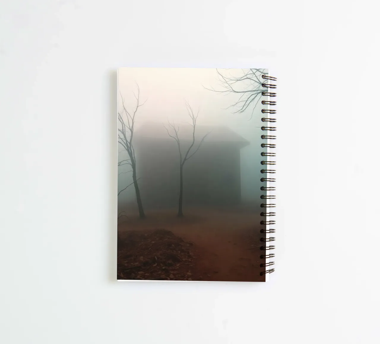 Fog envelops an isolated house surrounded by barren trees spiral notebook by DesignDoodle