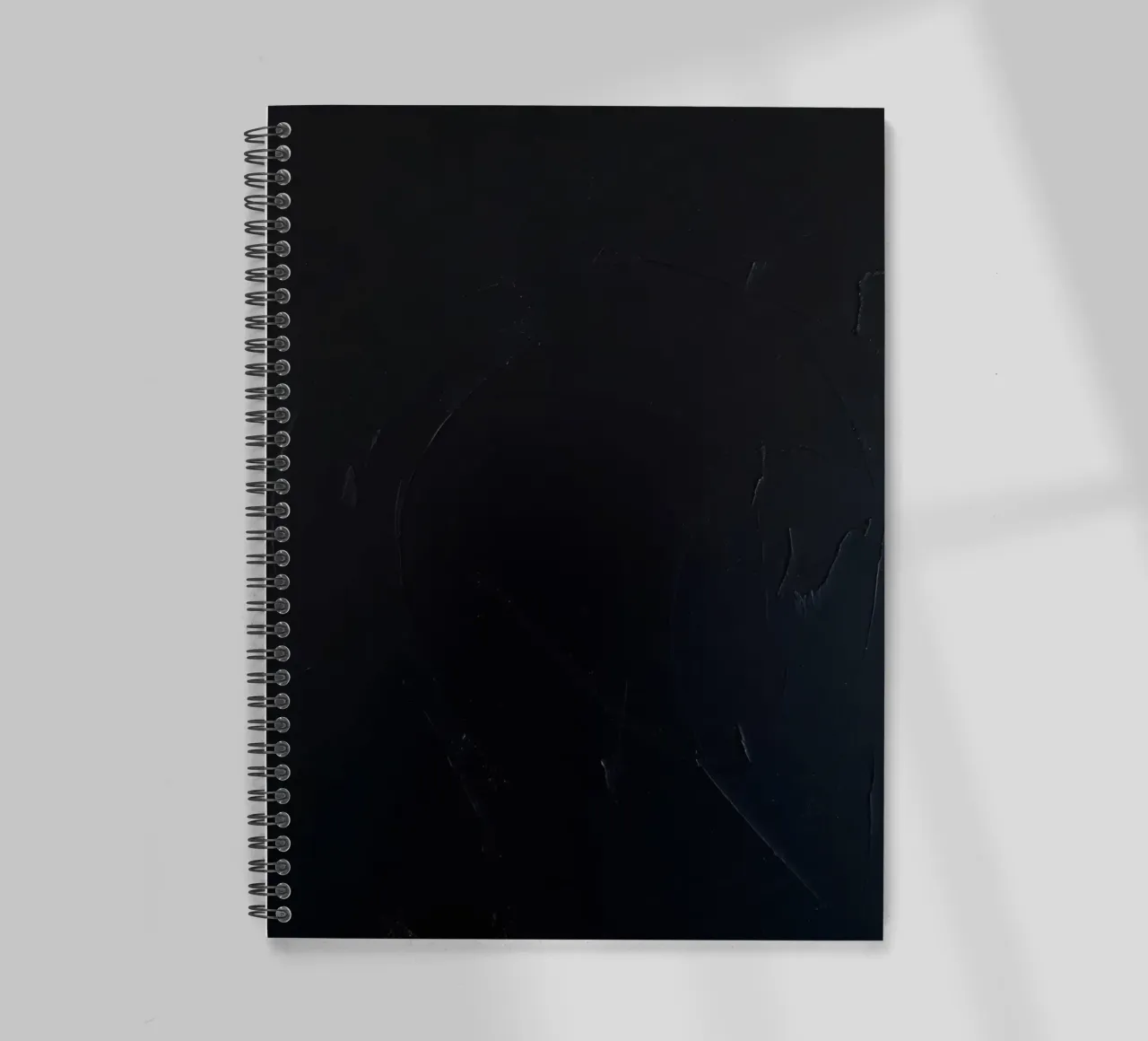 Dark textured surface with subtle variations in hues spiral notebook by DesignDoodle