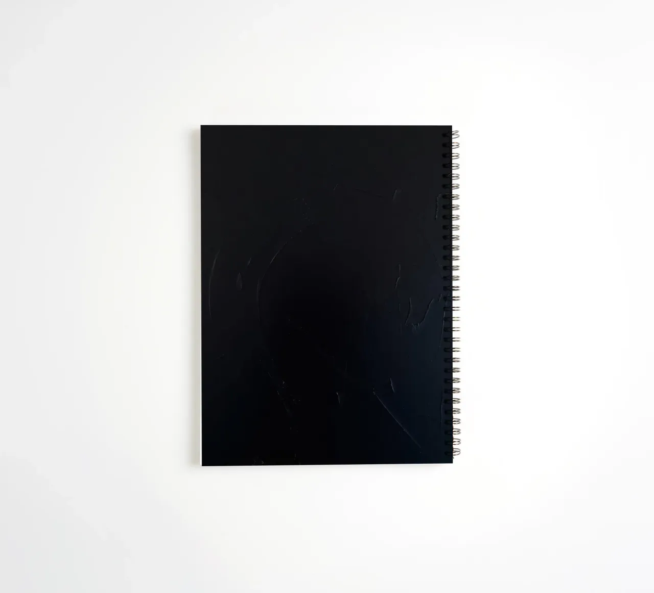 Dark textured surface with subtle variations in hues spiral notebook by DesignDoodle