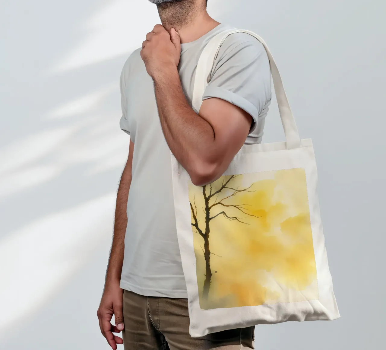 tree against a warm yellow background in a watercolor art tote bag by DesignDoodle
