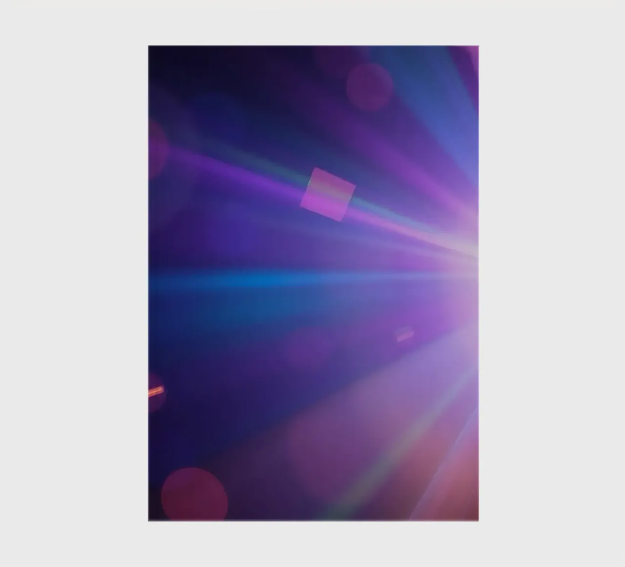 Colorful light rays create a vibrant display in a dark art notebook by DesignDoodle