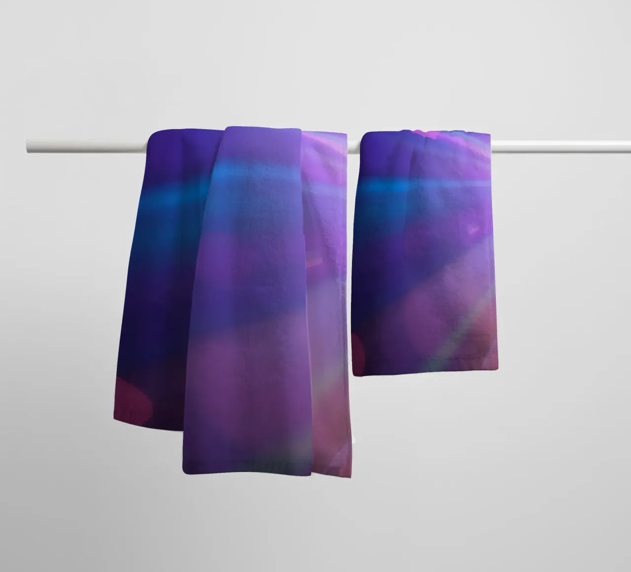 Colorful light rays create a vibrant display in a dark art towel by DesignDoodle