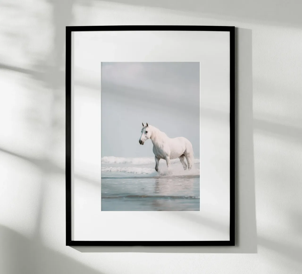 Caballo blanco galopando entre las olas del océano poster de Indigo Tides Art