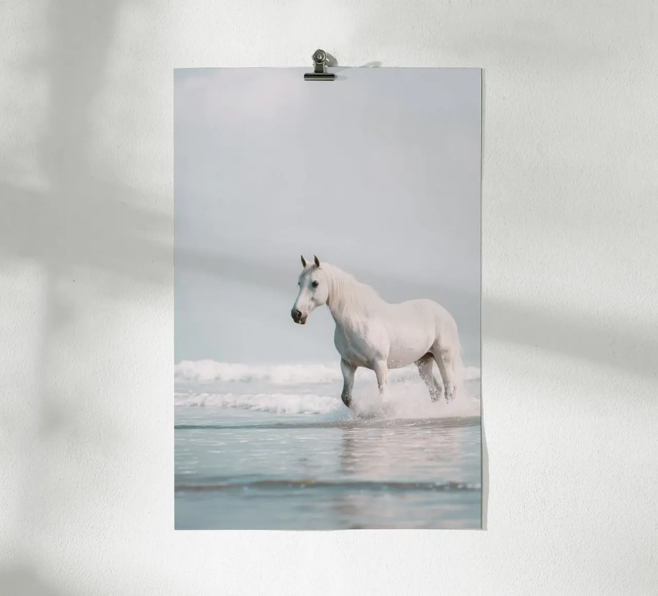 Caballo blanco galopando entre las olas del océano poster de Indigo Tides Art