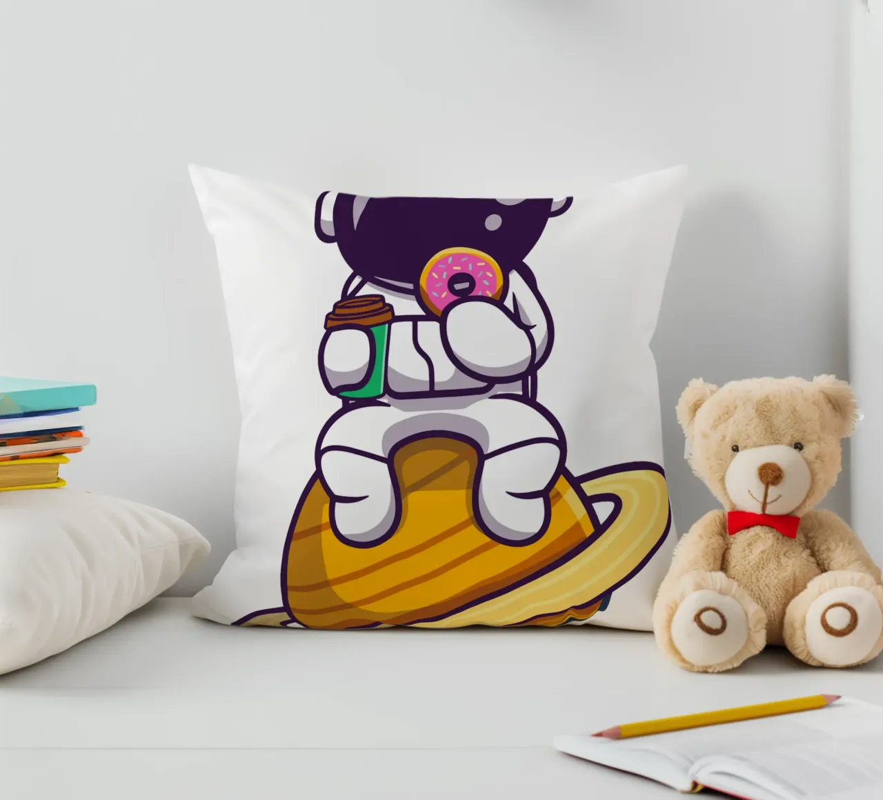 Astronauta carino che mangia una ciambella e tiene in mano una tazza di caffè cuscino da brockcon Shop