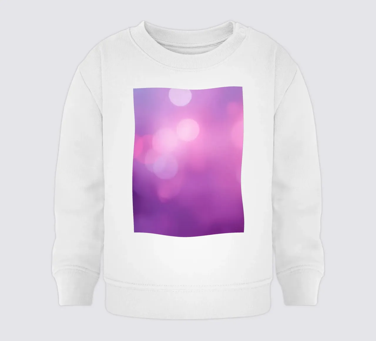 Gli effetti bokeh colorati creano un'atmosfera da sogno ad un livello di felpa neonato da DesignDoodle