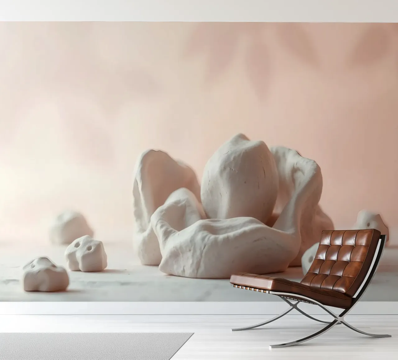 Clay sculptures arranged on a white surface with a soft pink photo wallpaper by DesignDoodle