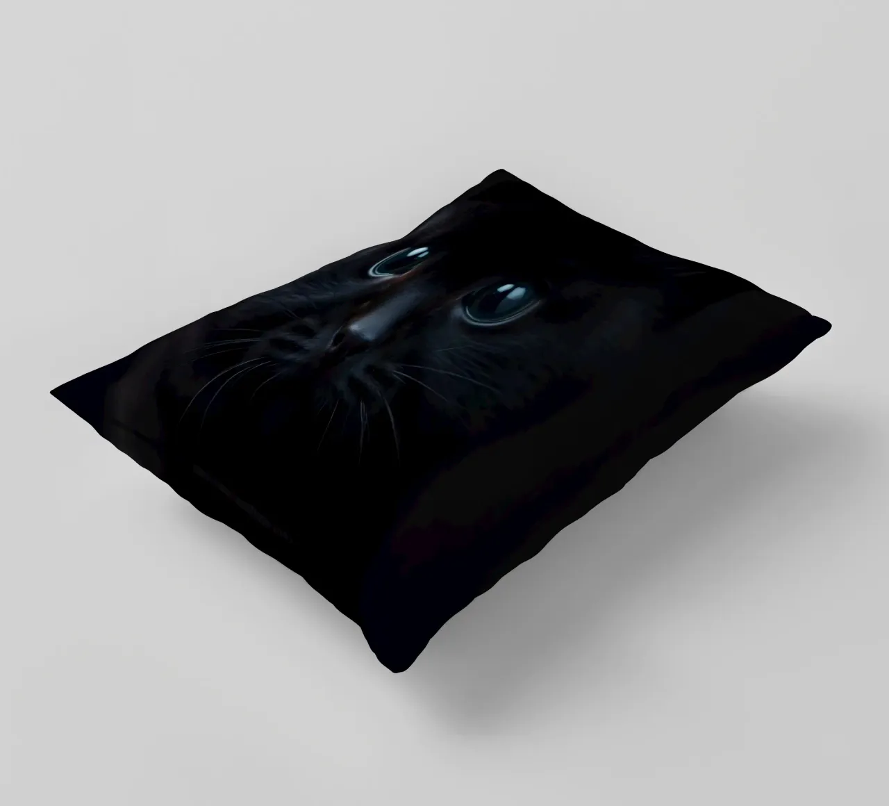 Black kitten with blue eyes gazing curiously against a dark decorative cushion by DesignDoodle