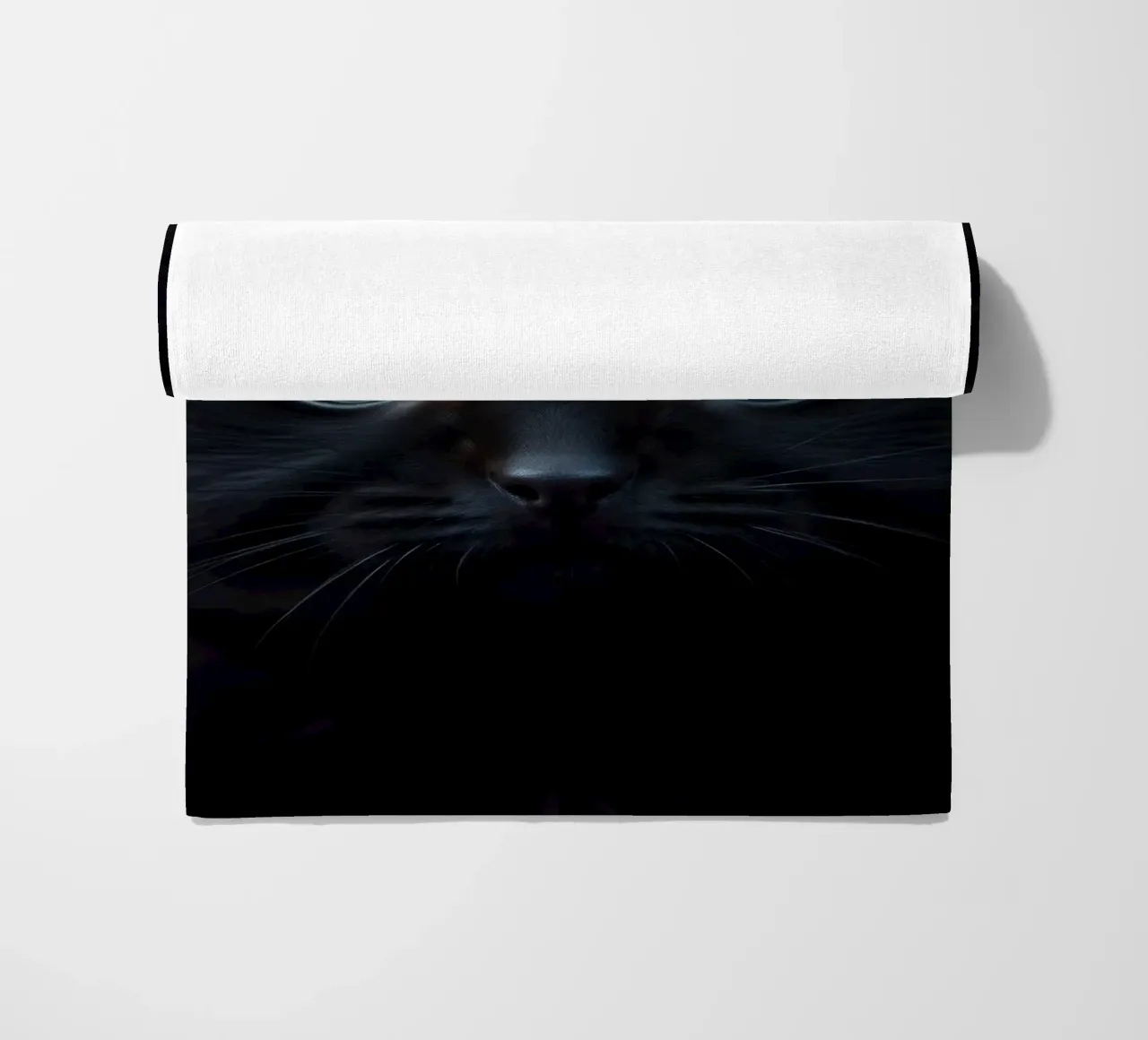 Black kitten with blue eyes gazing curiously against a dark beach towel by DesignDoodle
