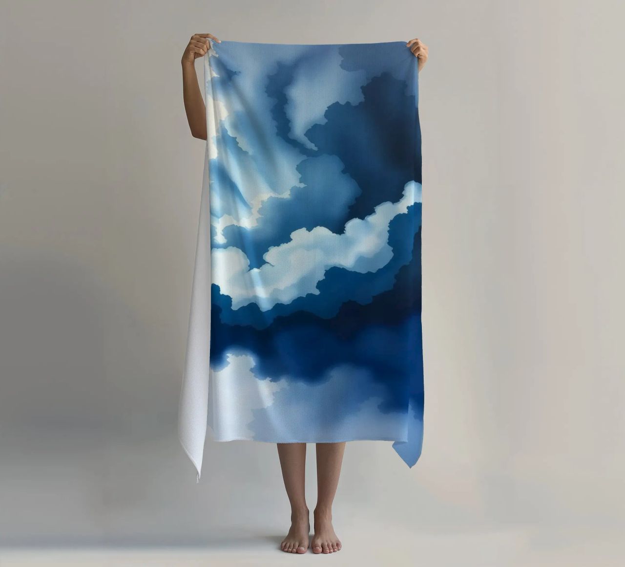 Bright clouds reflect light in a calm bluish atmosphere beach towel by DesignDoodle
