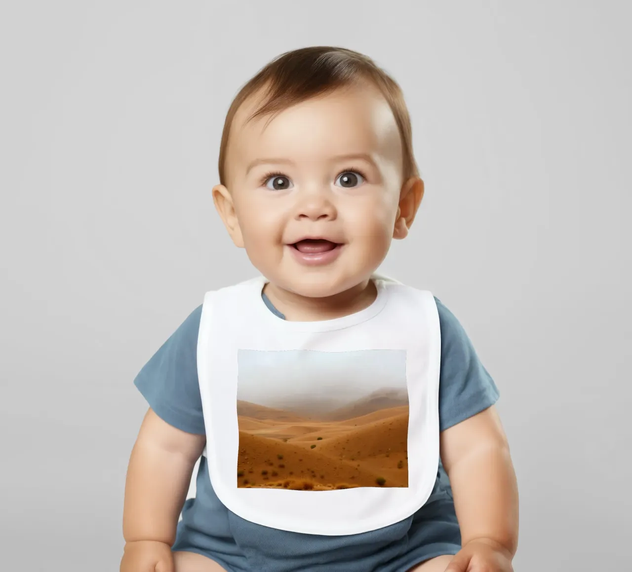 desert landscape under cloudy sky with gentle rolling dunes baby bib by DesignDoodle