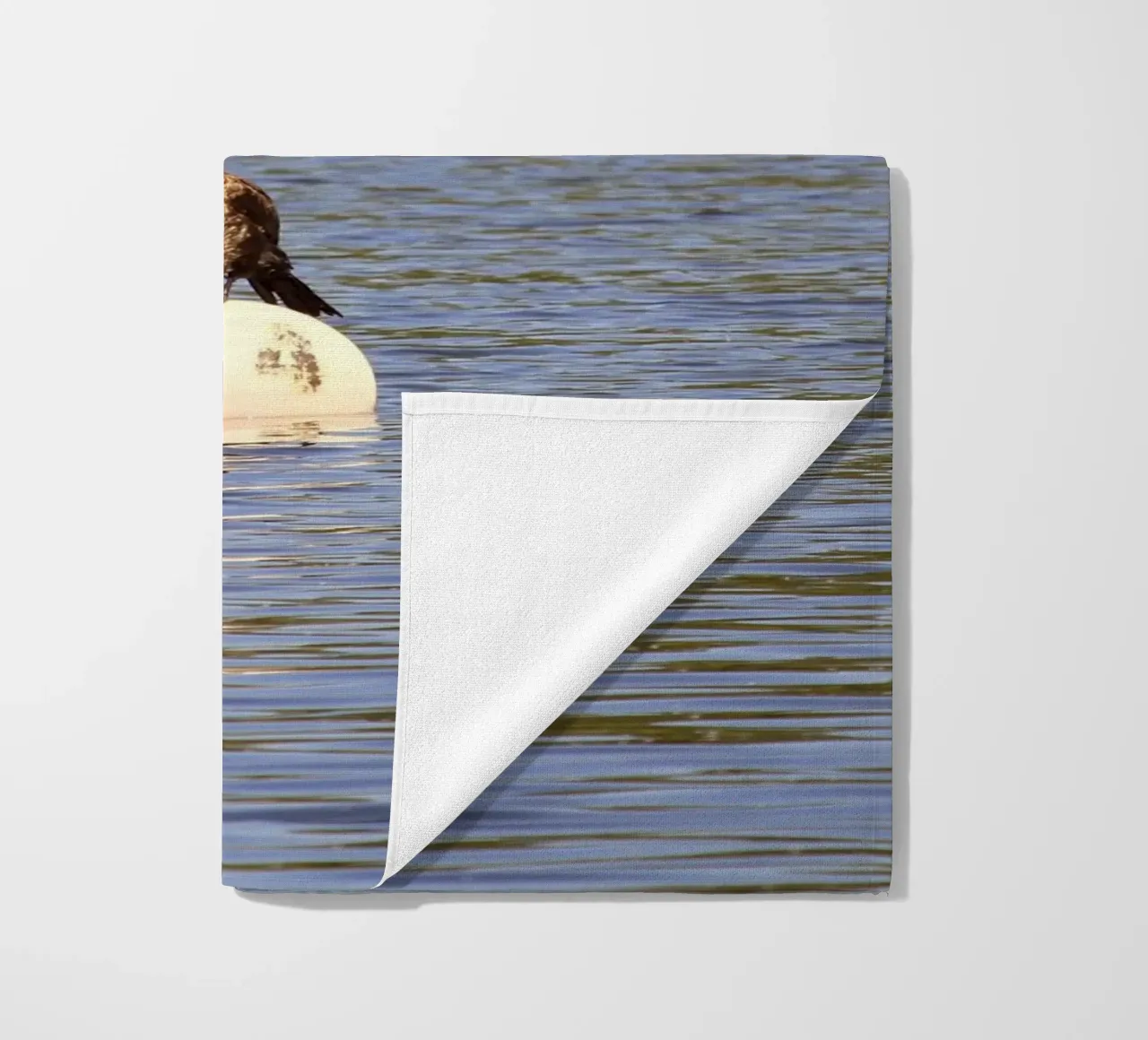 Cormorant Perched on a Buoy in the Lake beach towel by Jack C Photography