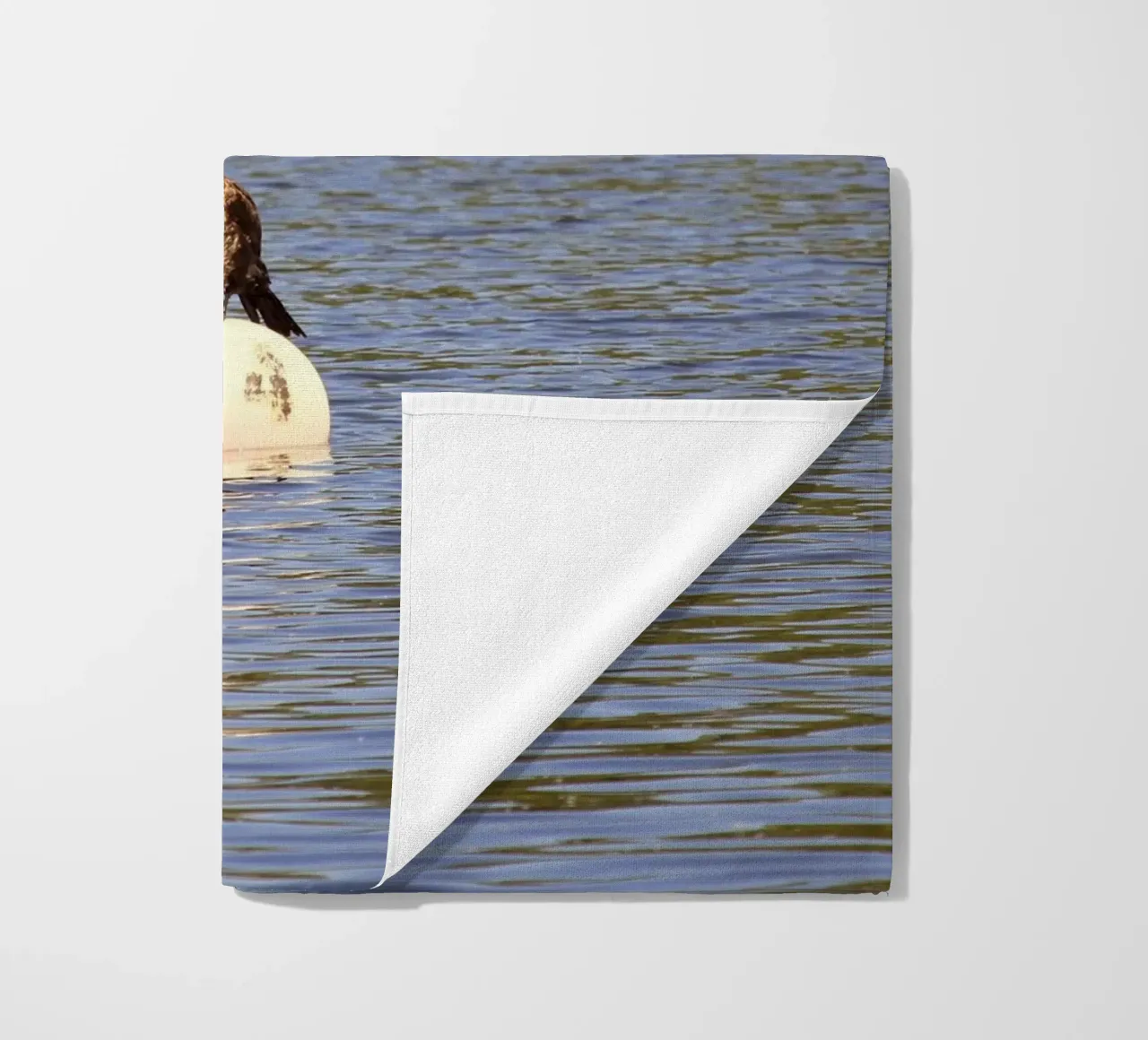 Cormorant Perched on a Buoy in the Lake beach towel by Jack C Photography