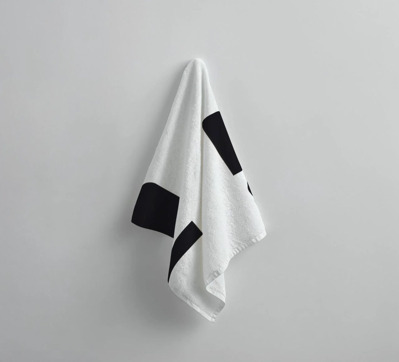 Abstract design featuring black shapes on a white background towel by DesignDoodle