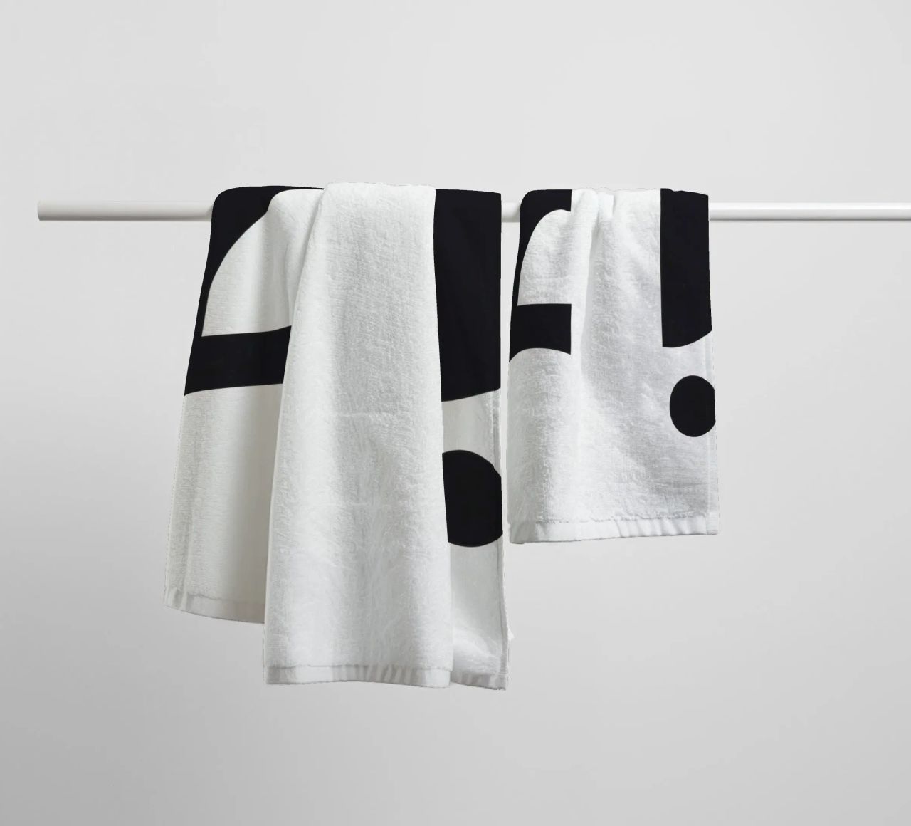 Abstract design featuring black shapes on a white background towel by DesignDoodle
