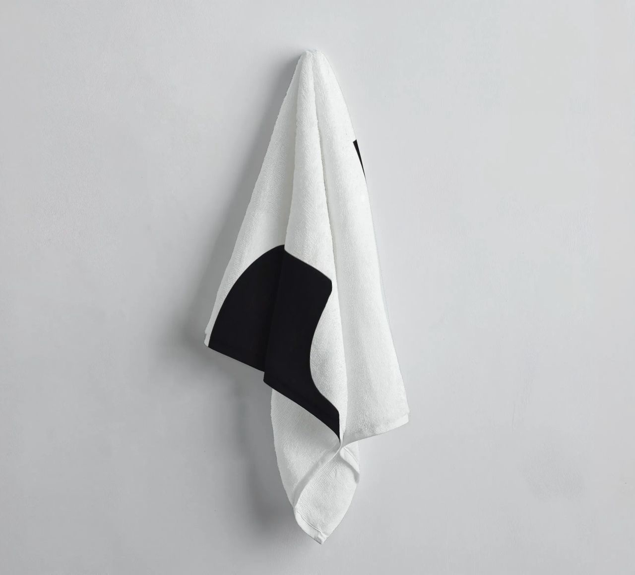 Abstract design featuring black shapes on a white background towel by DesignDoodle