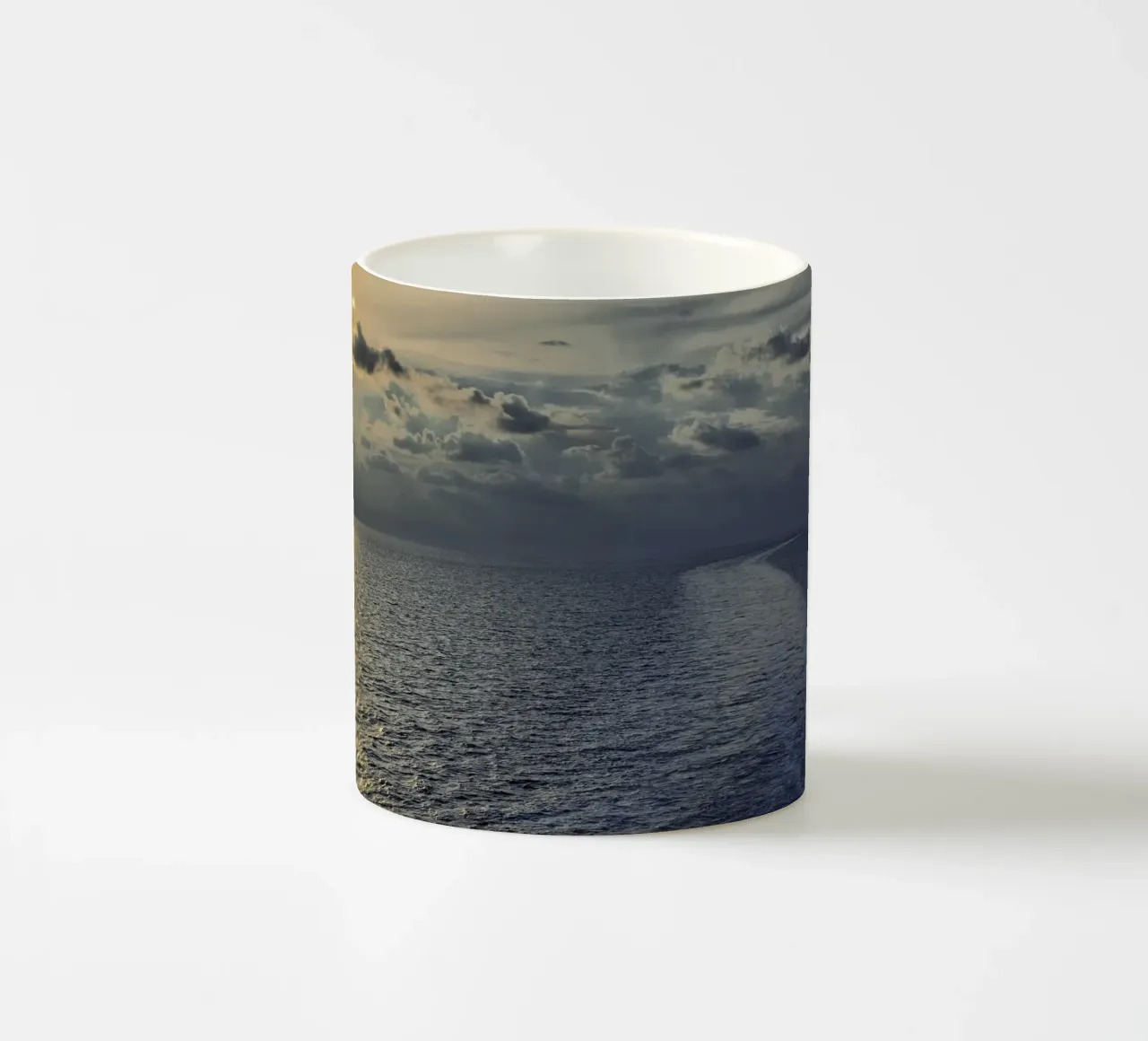 Golden light on the ocean at sunset or sunrise. ceramic mug by peuceta_BA
