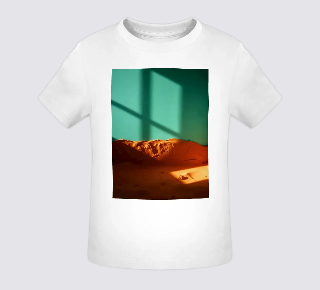 sunlight casts geometric shadows on orange sand and turquois baby t-shirt by DesignDoodle
