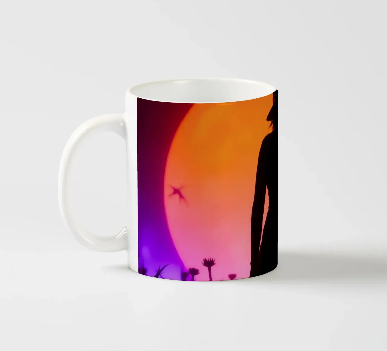 Silhouette di donna con cappello, tramonto con insetti volanti tazza in ceramica da DesignDoodle