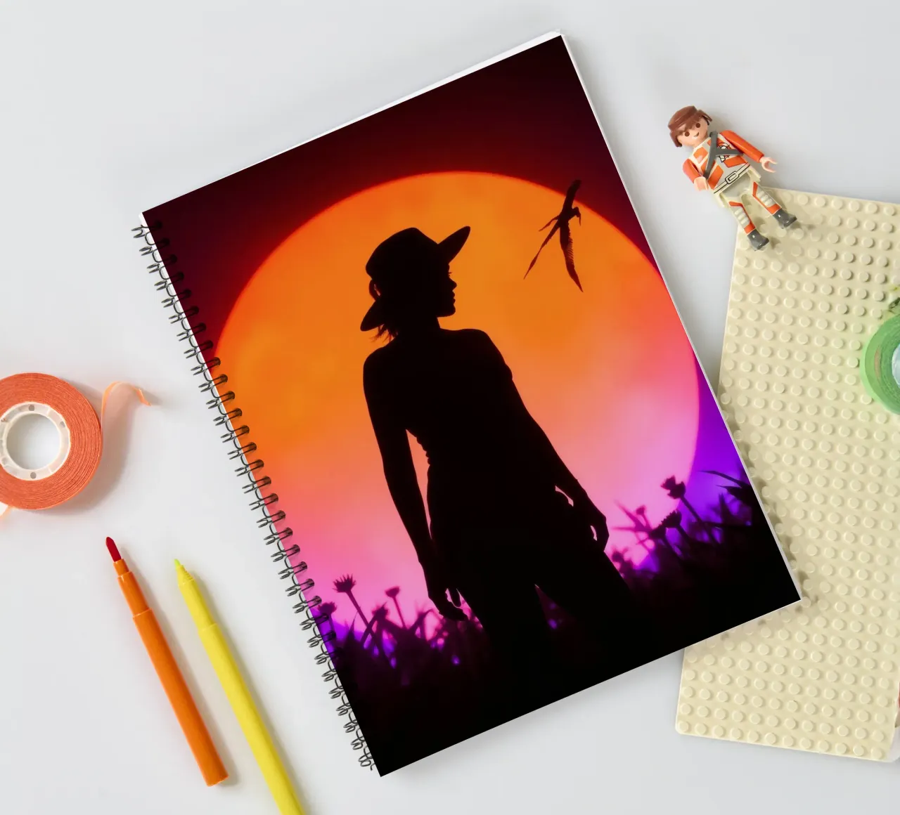 Silhouette of a woman in a hat, sunset with flying insects spiral notebook by DesignDoodle