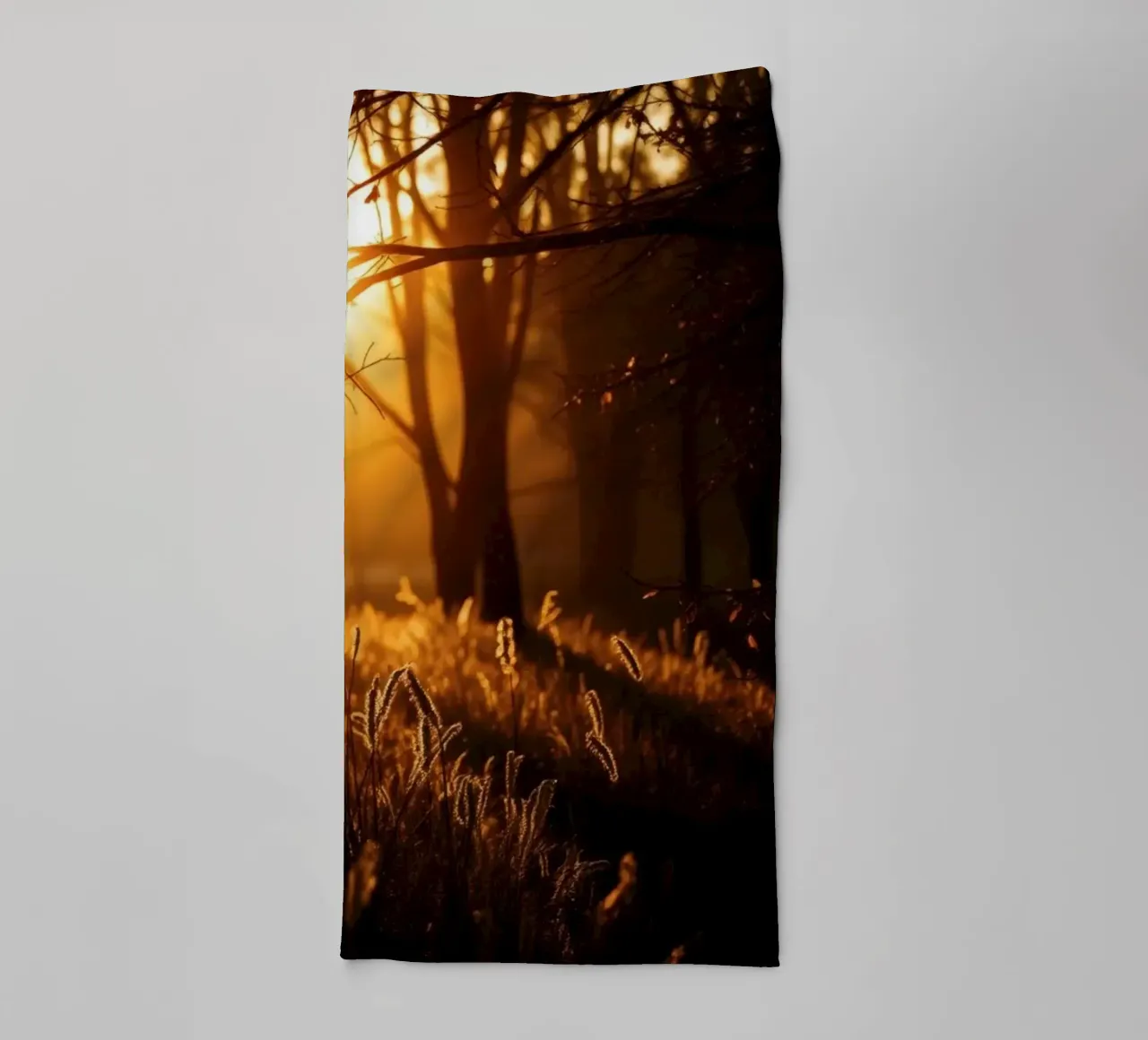Golden sunlight filters through trees in a tranquil forest towel by DesignDoodle