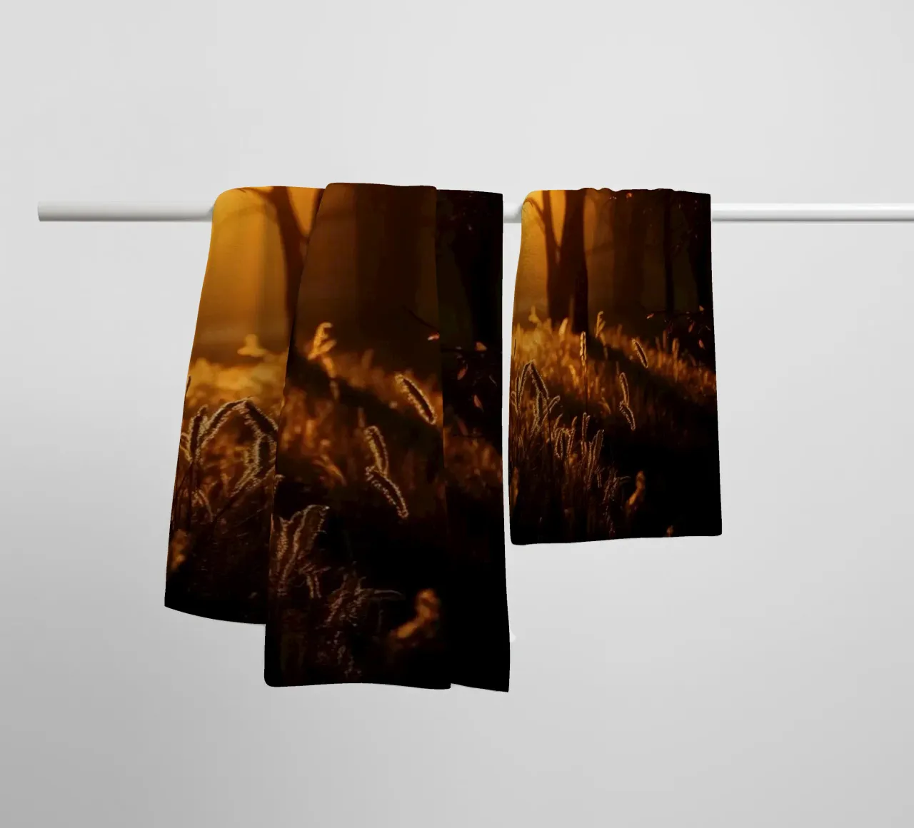 Golden sunlight filters through trees in a tranquil forest towel by DesignDoodle