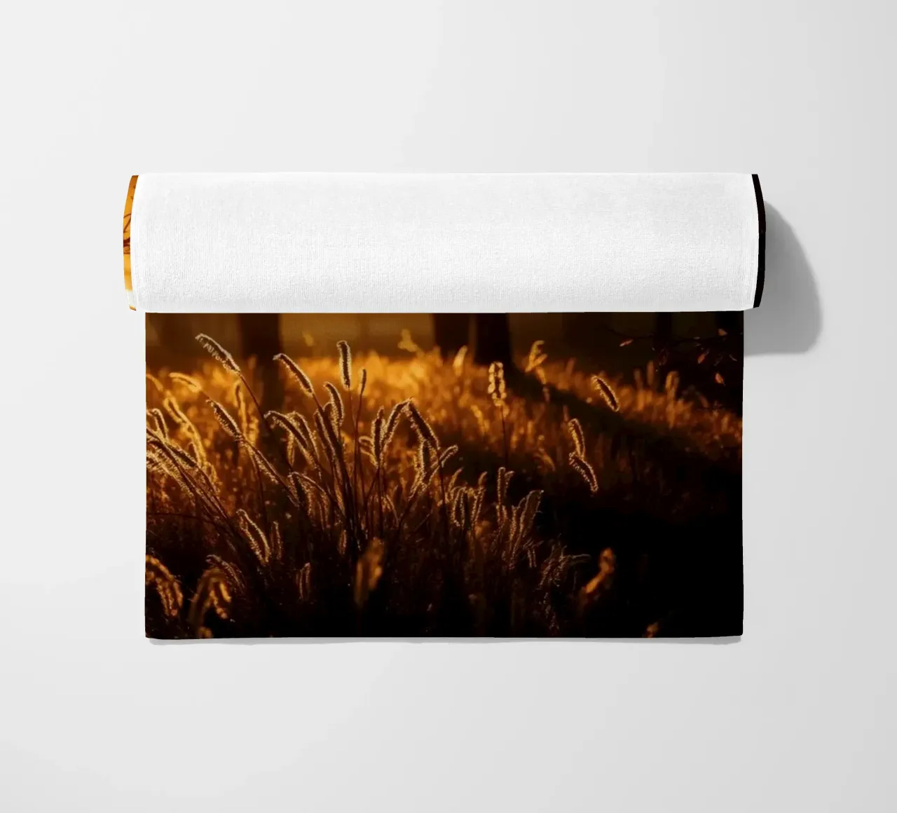 Golden sunlight filters through trees in a tranquil forest beach towel by DesignDoodle