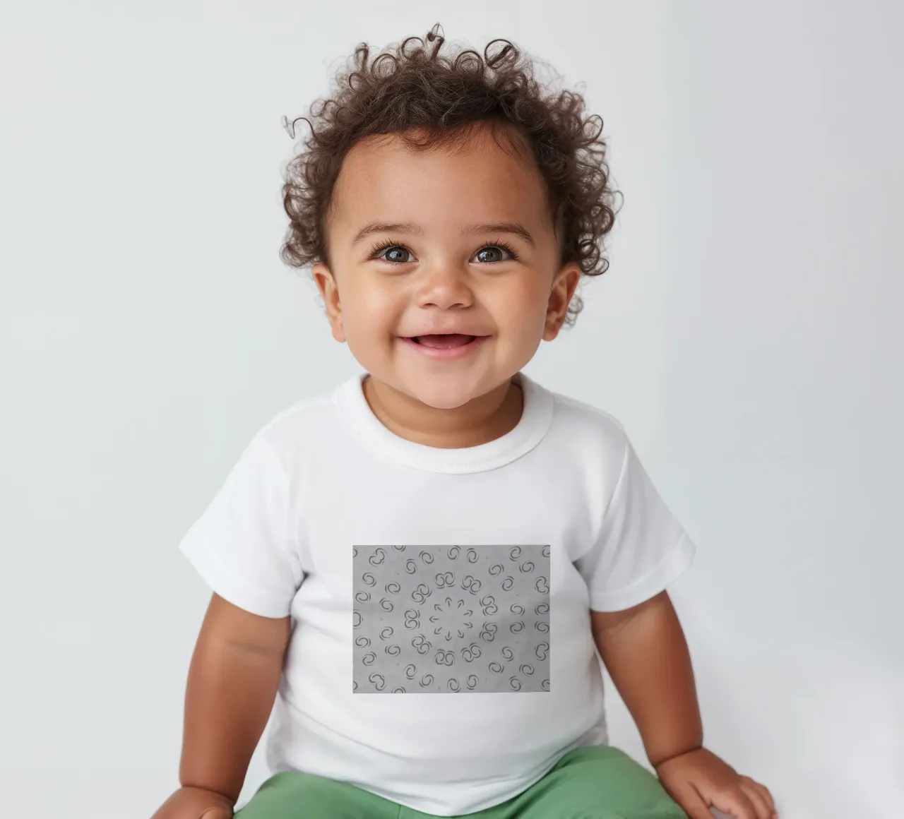 Abstract dynamic circular pattern in grey baby t-shirt by Something for you