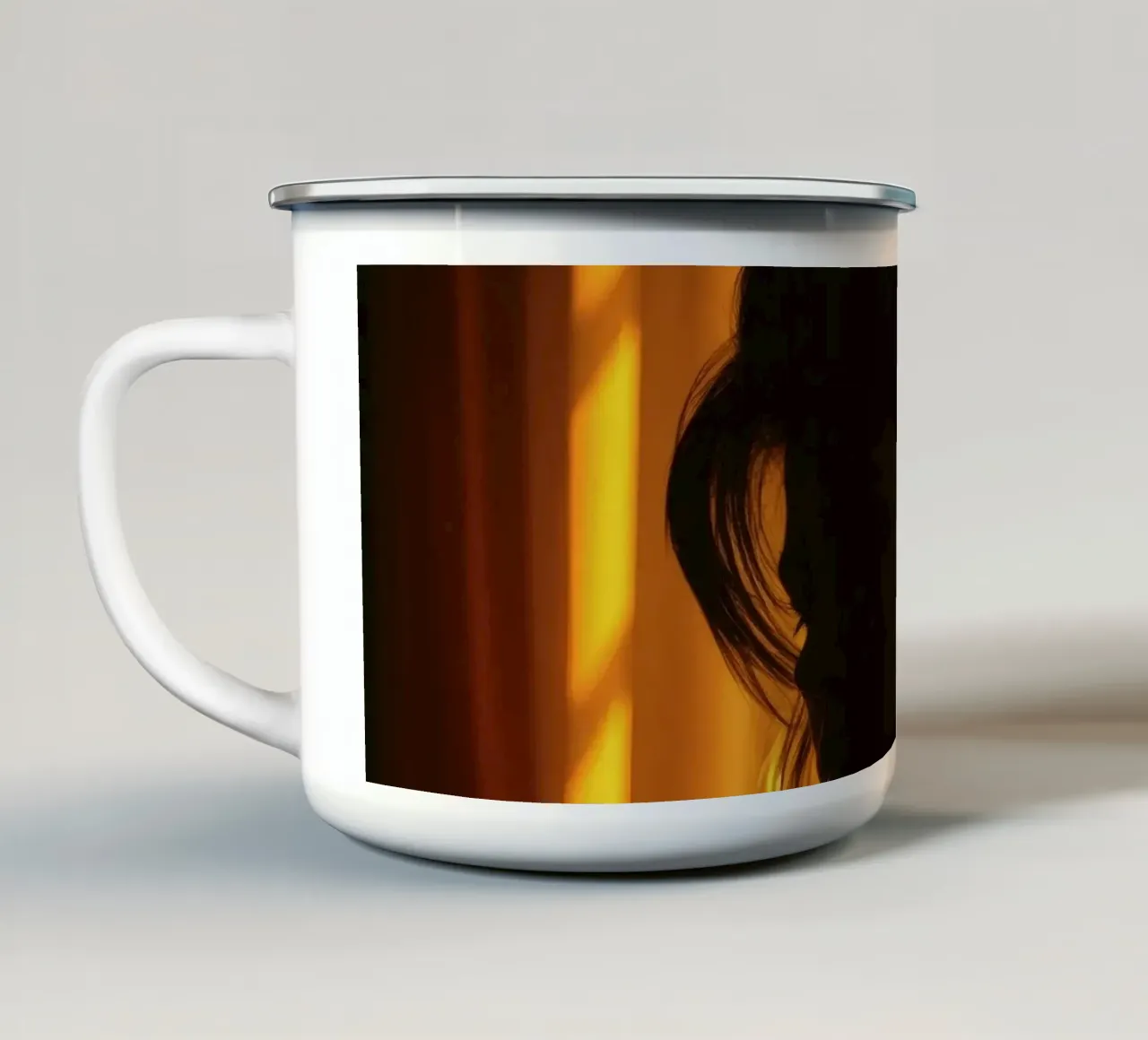 Una luce morbida e dorata delinea la figura di una persona contro una tenda trasparente tazza in smalto da DesignDoodle
