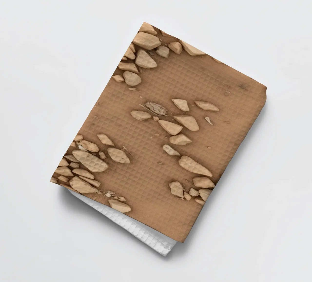 Disposizione naturale di piccole pietre sparse su un fondo marrone canovaccio da cucina da DesignDoodle