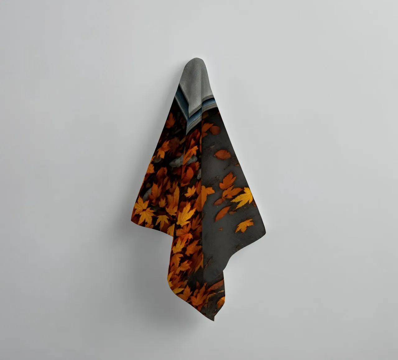 Golden autumn leaves scatter on the ground near a stone path towel by DesignDoodle