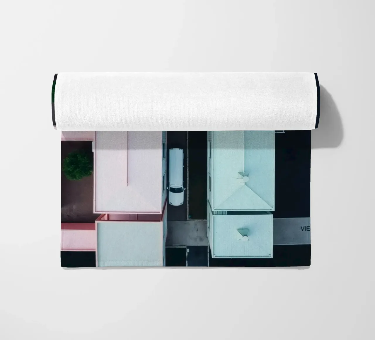 Unique aerial view of pastel-colored buildings with trees beach towel by DesignDoodle