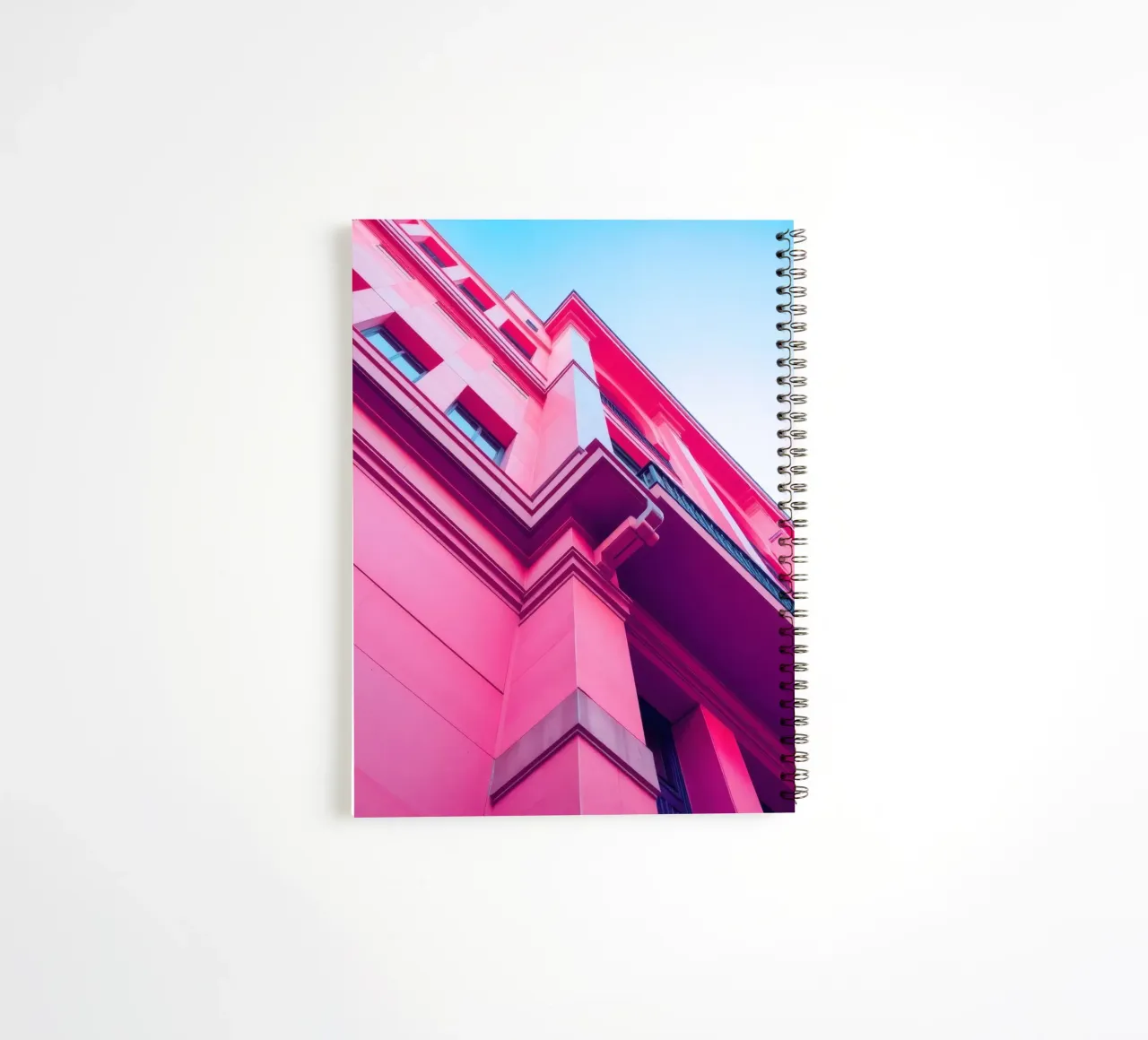 Modern architectural design featuring vibrant pink building spiral notebook by DesignDoodle
