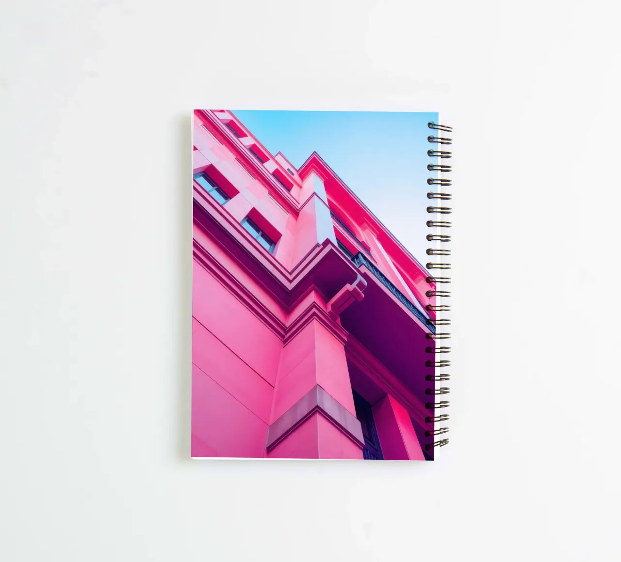 Modern architectural design featuring vibrant pink building spiral notebook by DesignDoodle