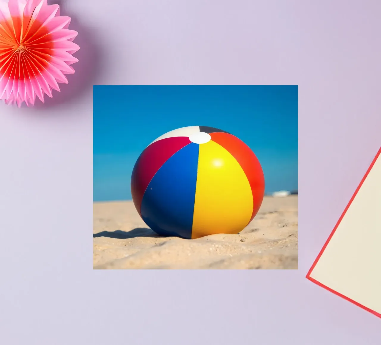 un ballon de plage est posé sur un rivage sablonneux sous un ciel bleu éclatant. autocollant de DesignDoodle