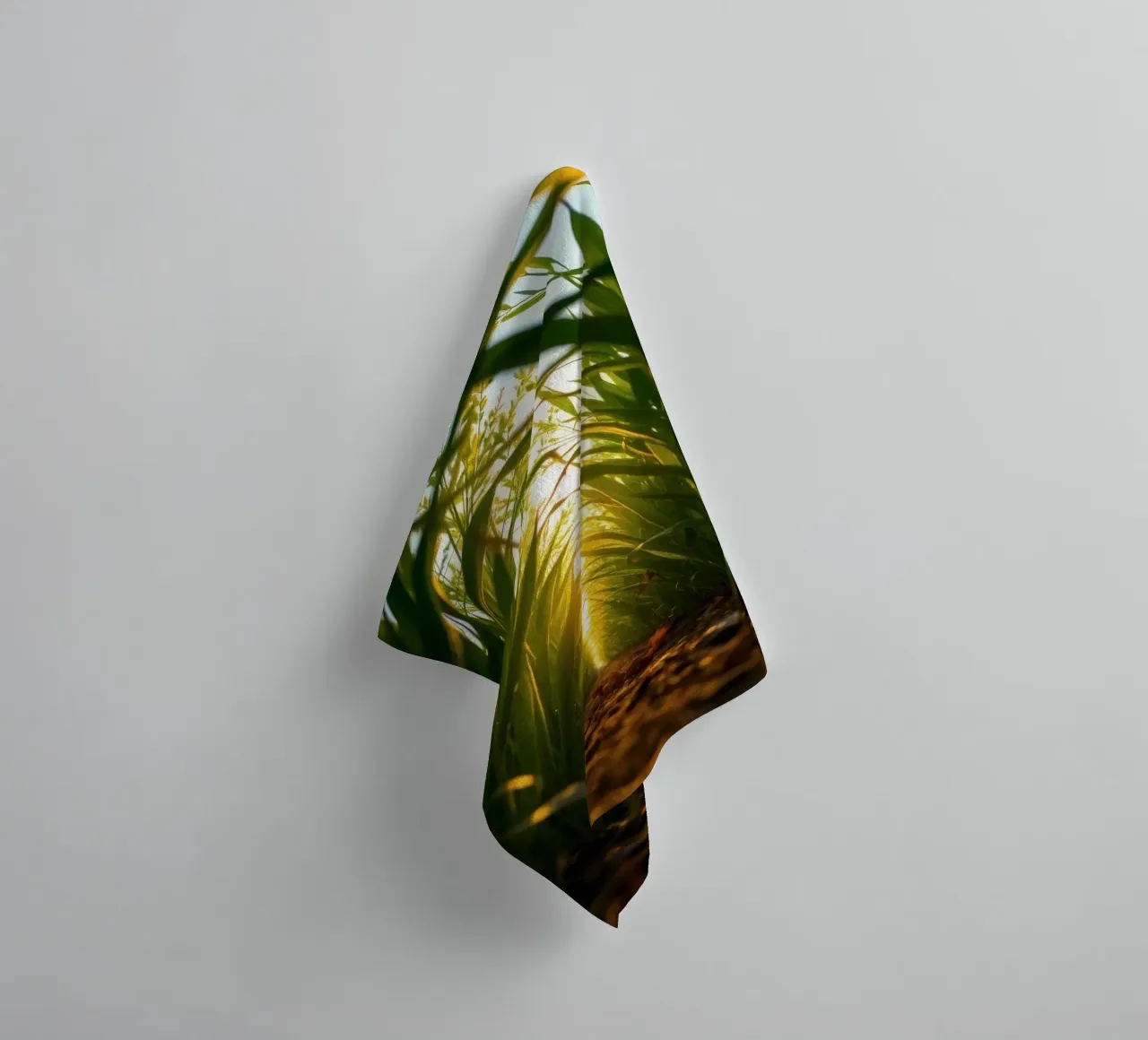 Sunlight filters through tall grass in a calm field towel by DesignDoodle