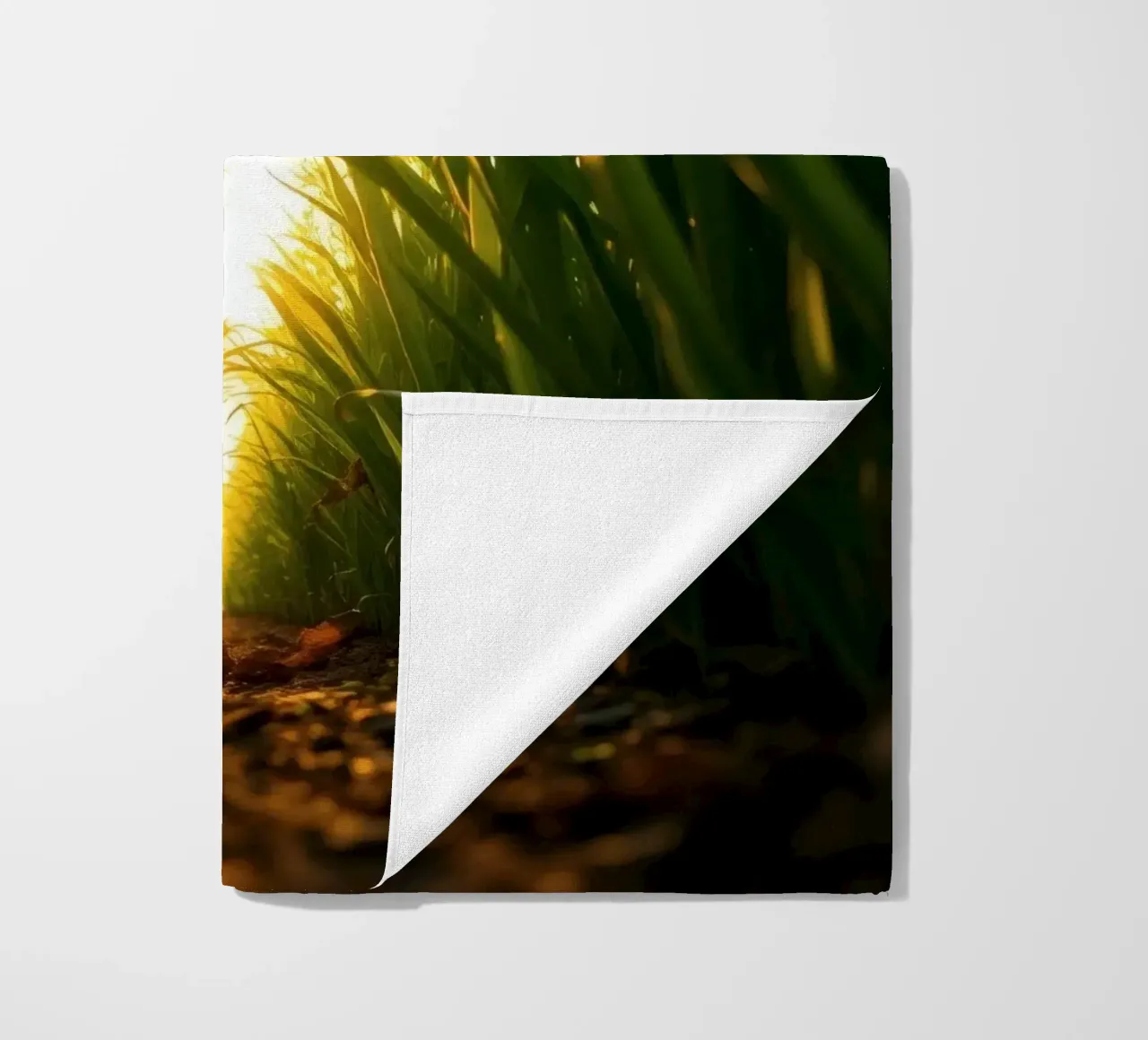 Sunlight filters through tall grass in a calm field beach towel by DesignDoodle