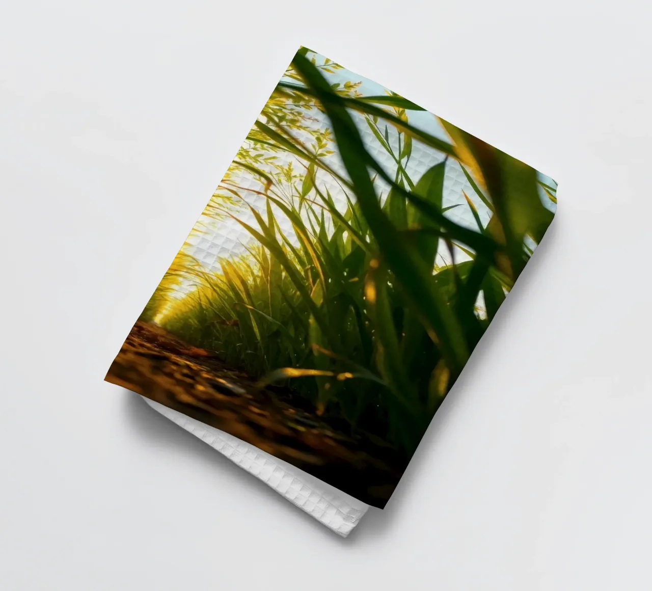 Sunlight filters through tall grass in a calm field tea towel by DesignDoodle