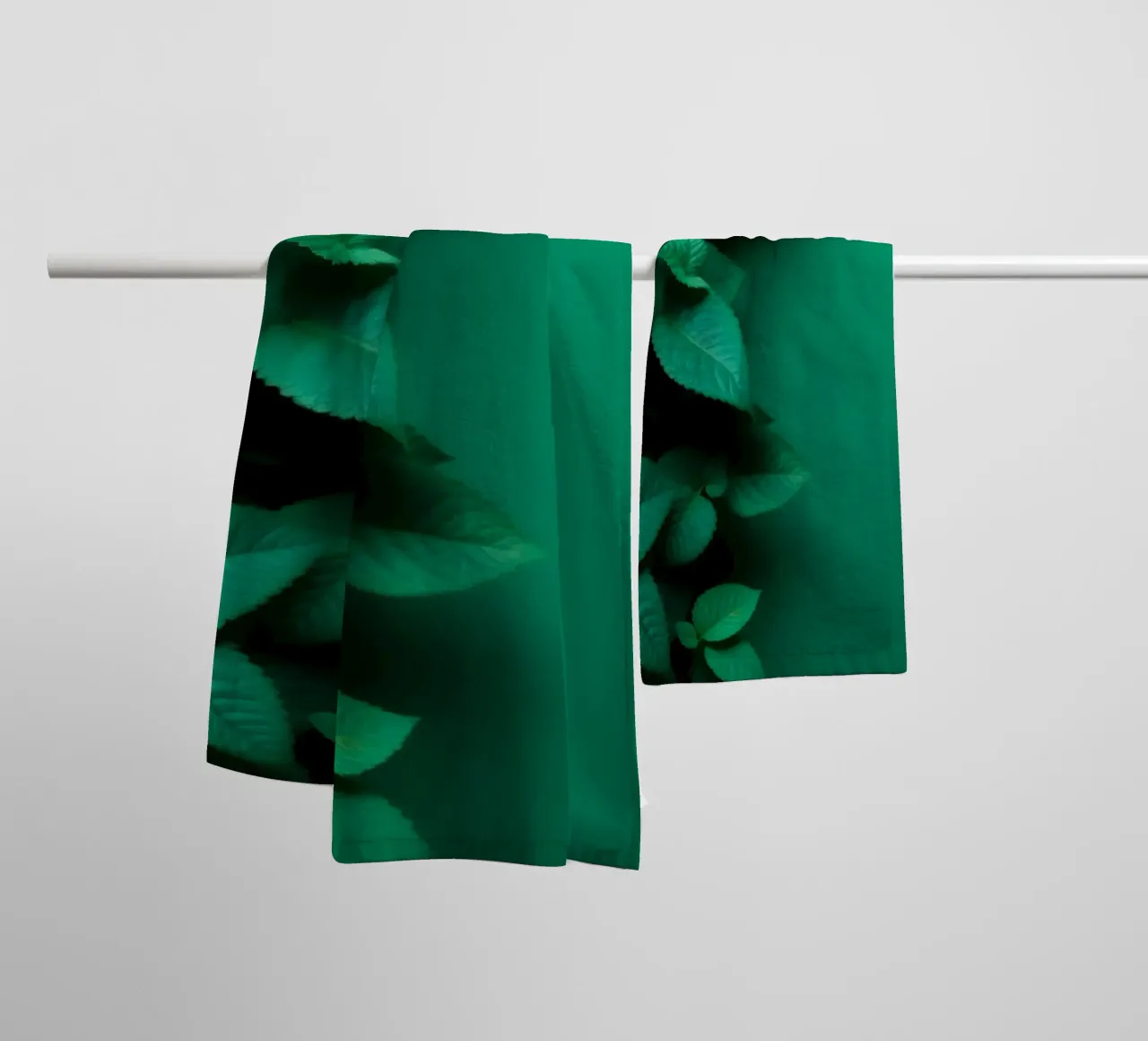 Lush green leaves create a backdrop in a calming nature towel by DesignDoodle