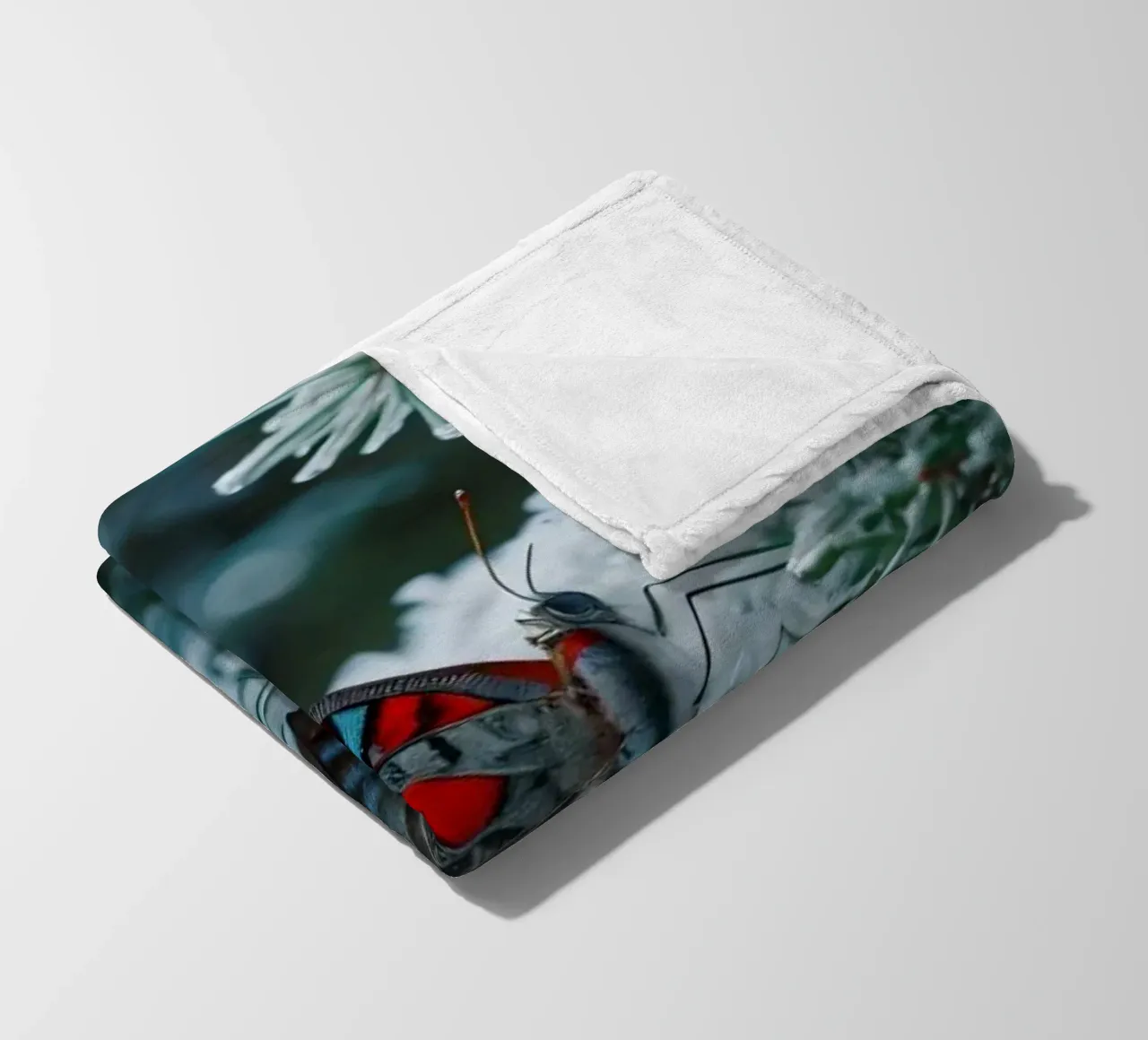 A butterfly resting on evergreen branches covered in frost fleece blanket by DesignDoodle
