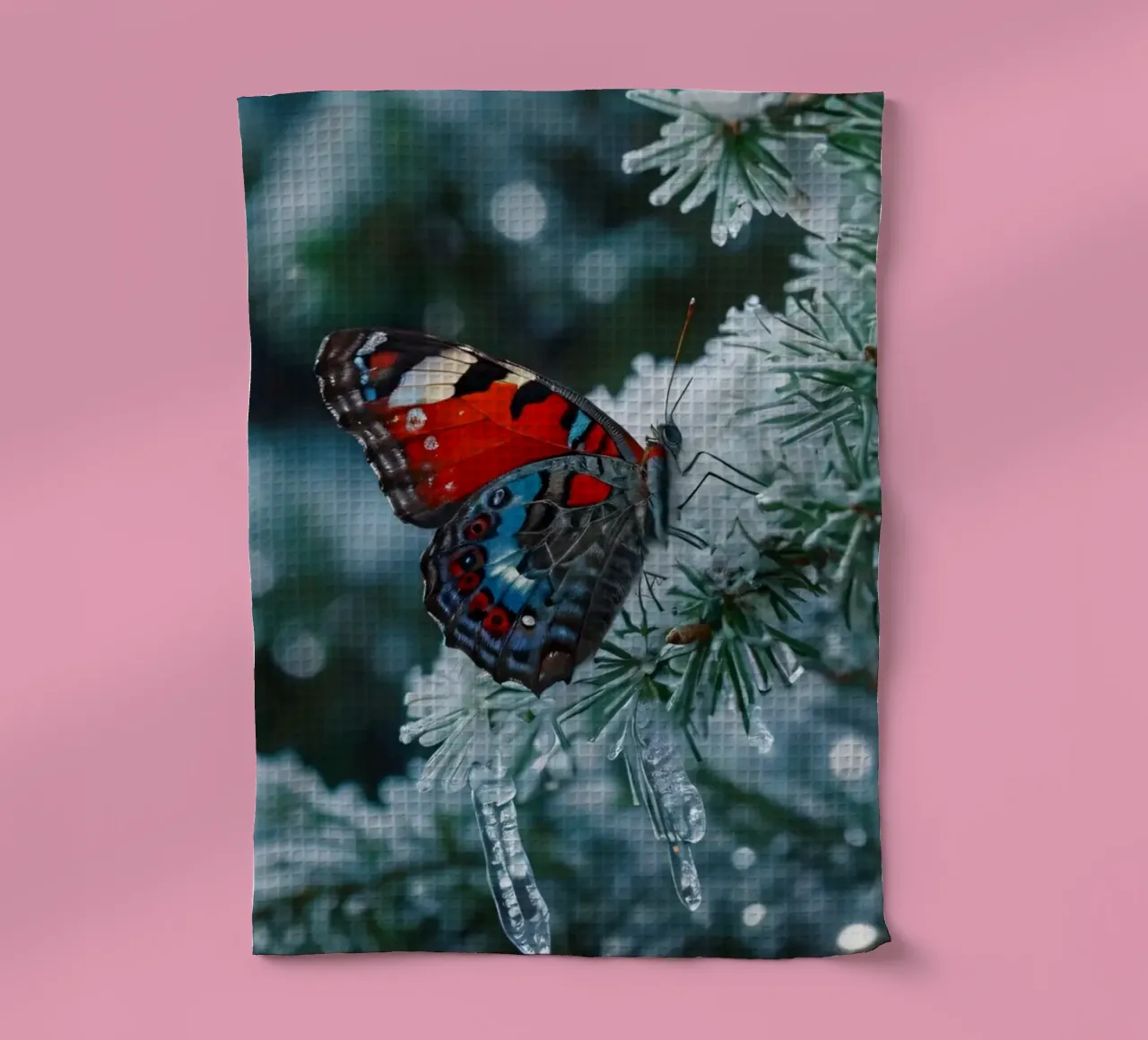 A butterfly resting on evergreen branches covered in frost tea towel by DesignDoodle
