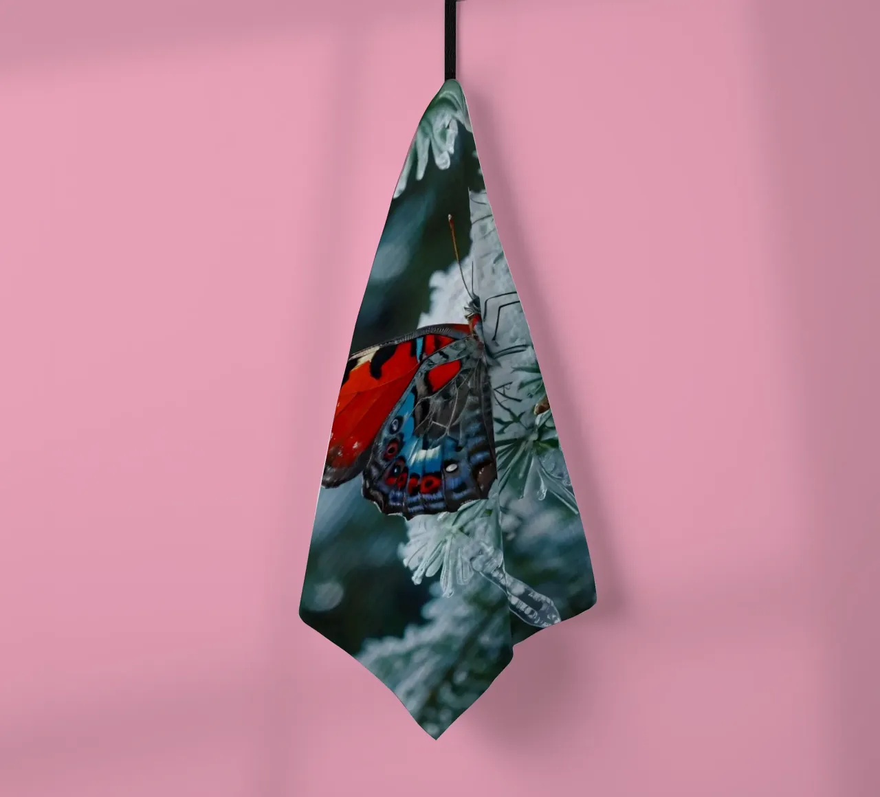 A butterfly resting on evergreen branches covered in frost tea towel by DesignDoodle