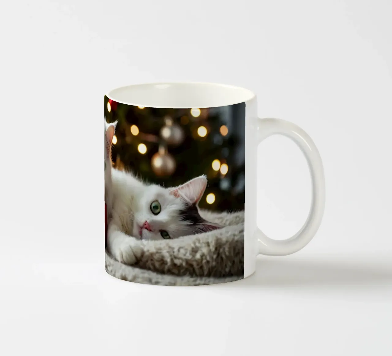 Two fluffy cats relaxing near a decorated Christmas tree ceramic mug by DesignDoodle
