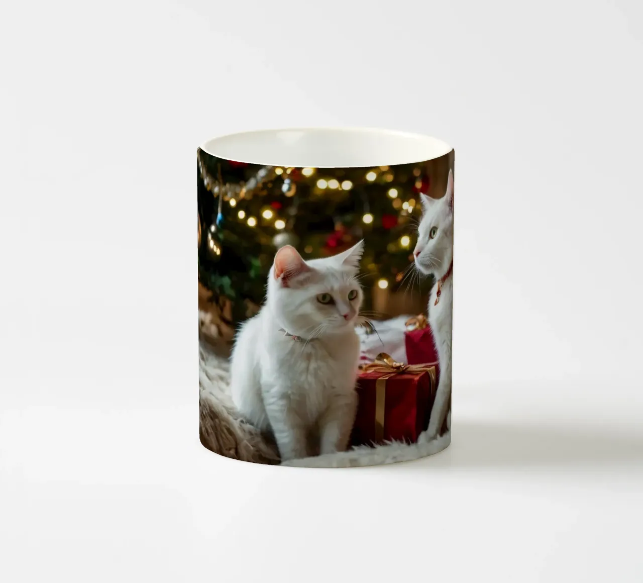 White cats sitting near a Christmas tree surrounded by gifts ceramic mug by DesignDoodle